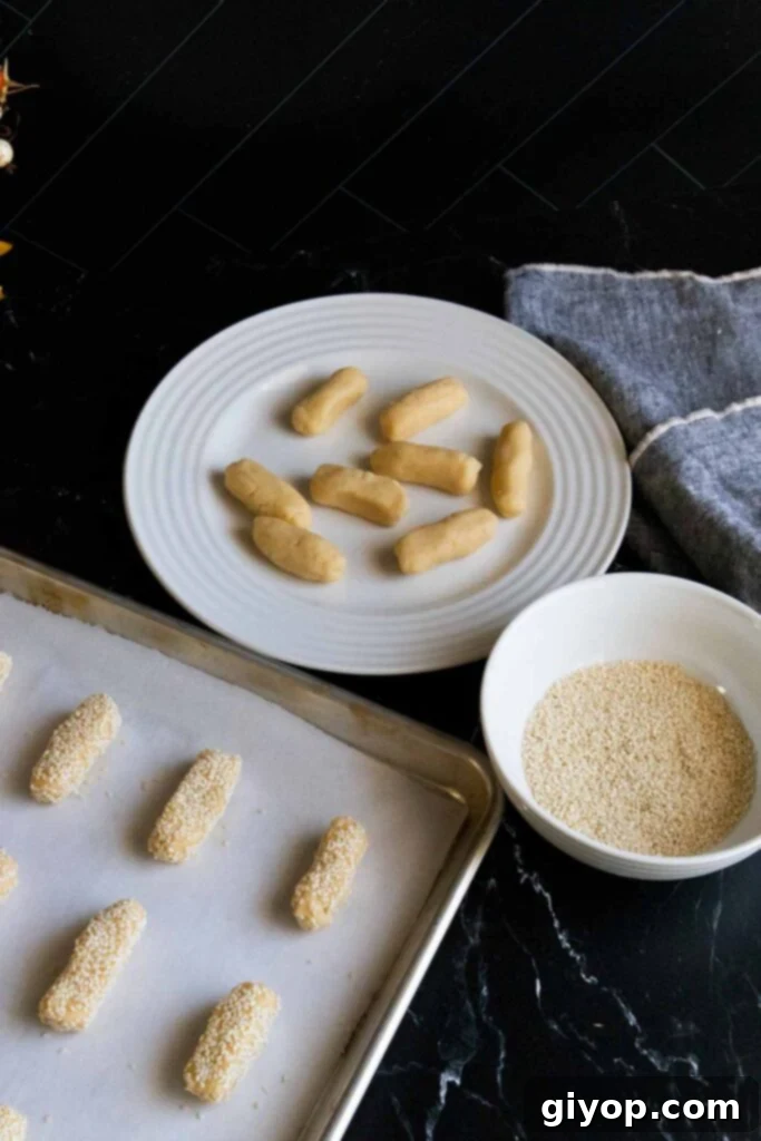 sesame cookie dough logs on parchment paper lined baking sheet