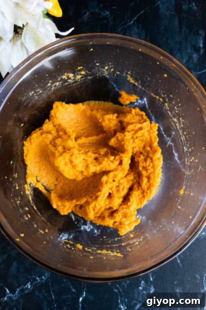 Southern Comfort Sweet Potato Pie 5 mashed sweet potatoes in a glass mixing bowl