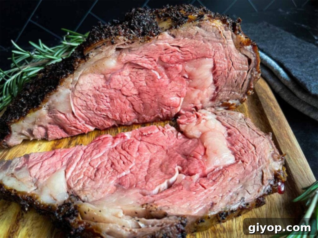 Slice prime rib on a cutting board garnished with fresh rosemary.