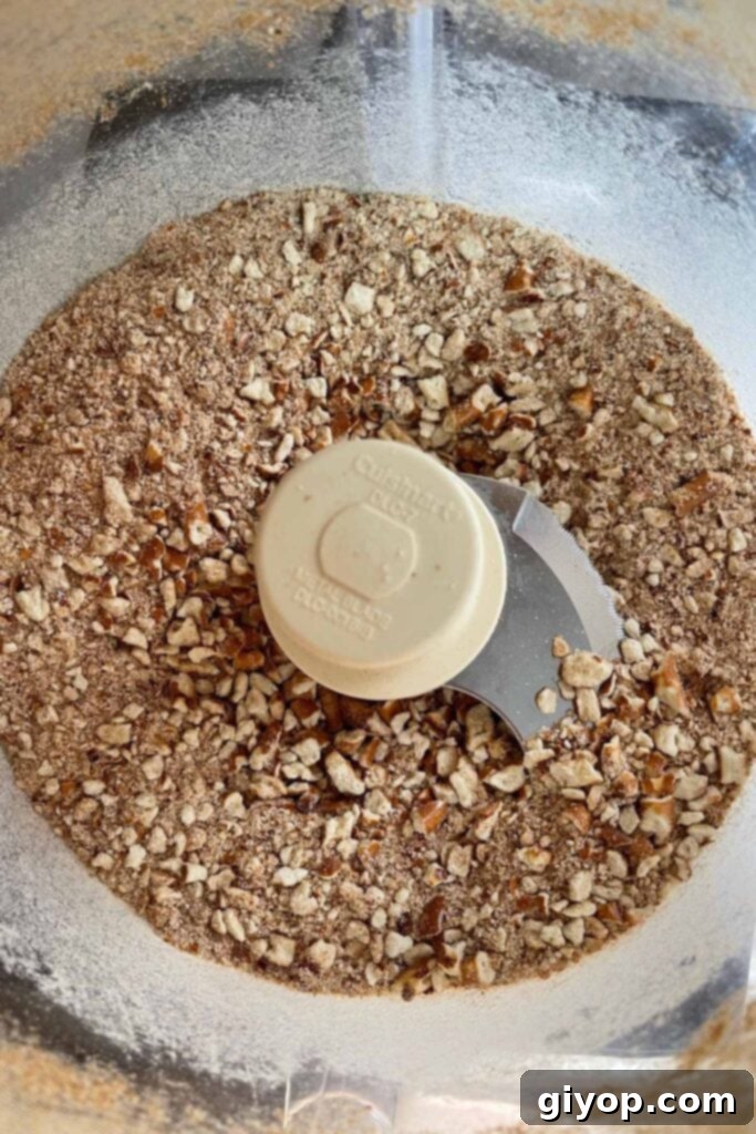 Pretzels crushed in a food processor bowl, ready for the peanut butter mixture.