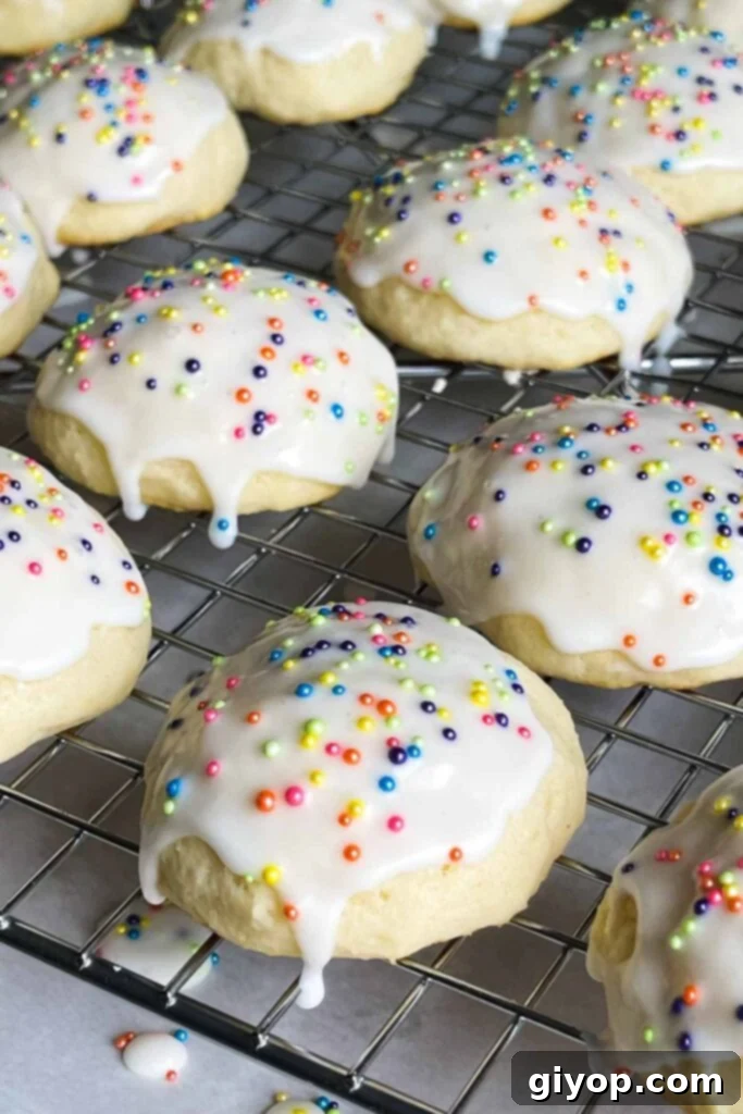 Italian ricotta cookies with glaze drying on a wire rack.