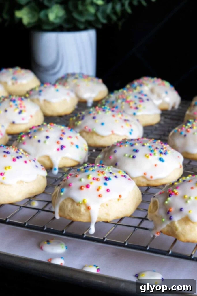 Italian ricotta cookies with glaze drying on a wire rack.