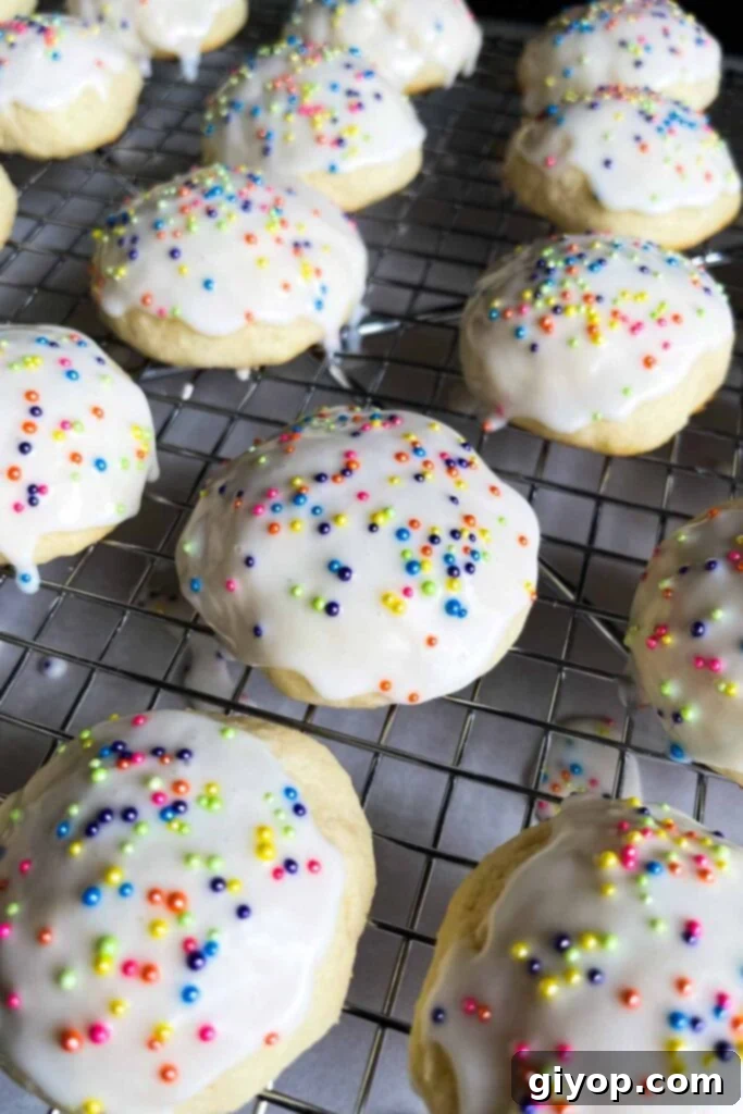 Italian ricotta cookies with glaze drying on a wire rack.
