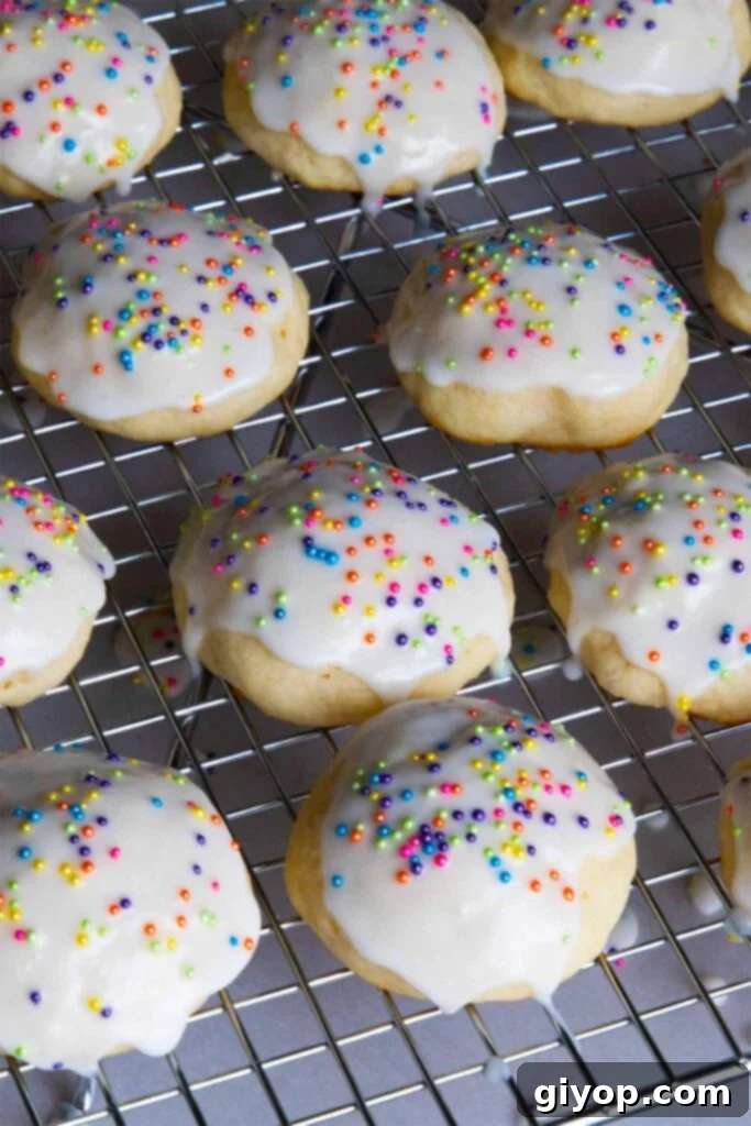 Italian ricotta cookies with glaze drying on a wire rack.