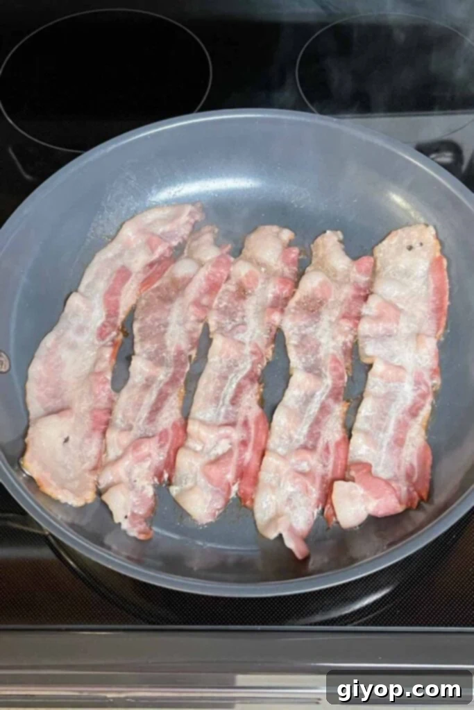 Bacon cooking in a pan.