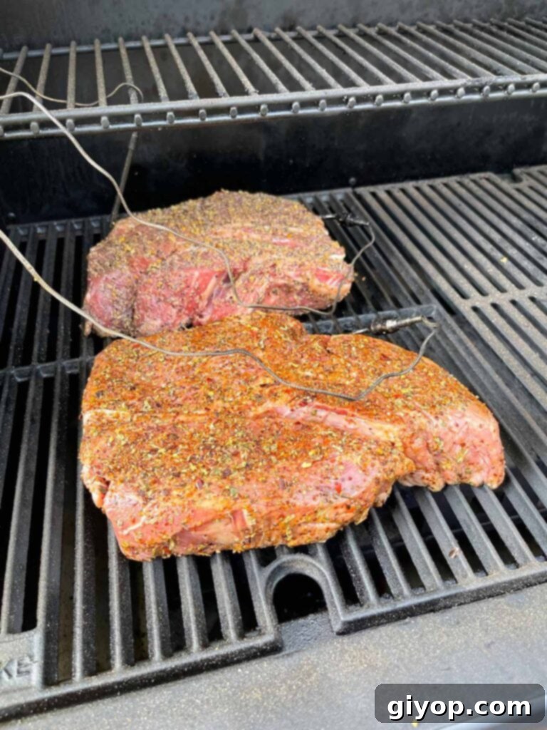 Two chuck roasts just placed into a smoker.