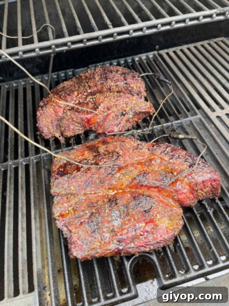 two chuck roasts on the smoker, about half way done.