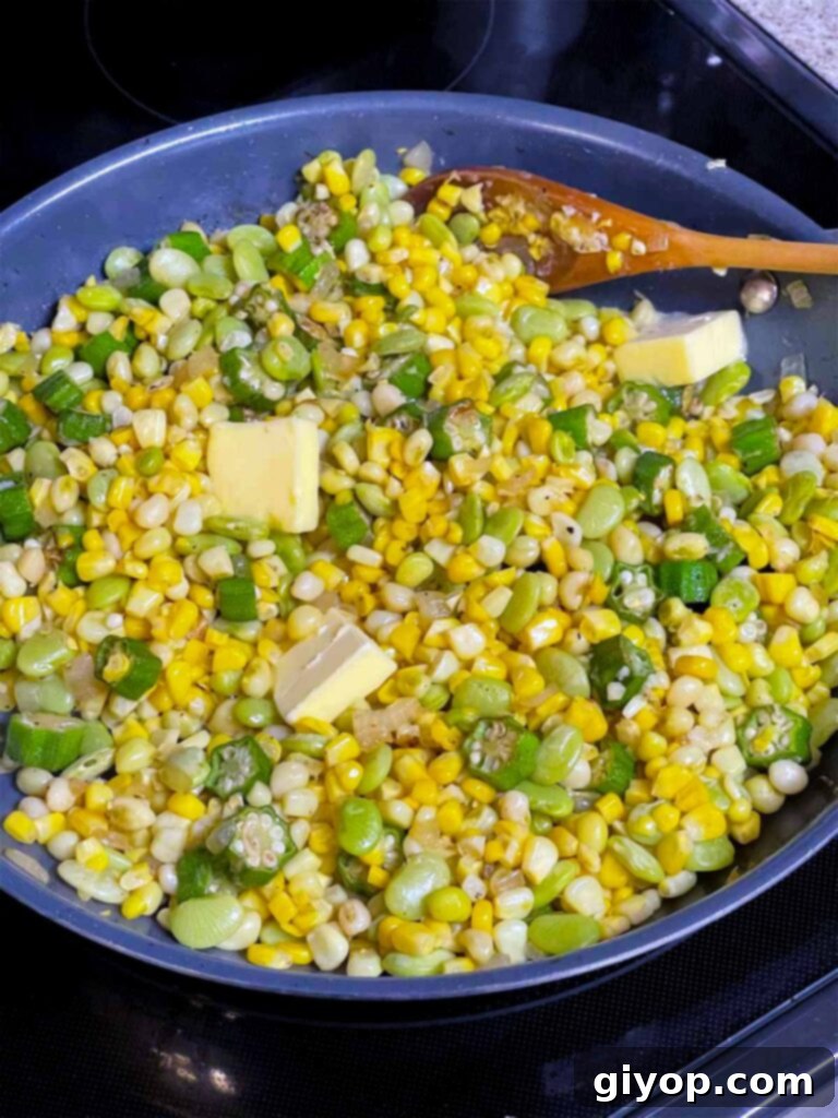 Fresh corn, cooked lima beans, and zipper peas being added to the sautéed okra and onions in a skillet, ready to be combined for the succotash recipe.