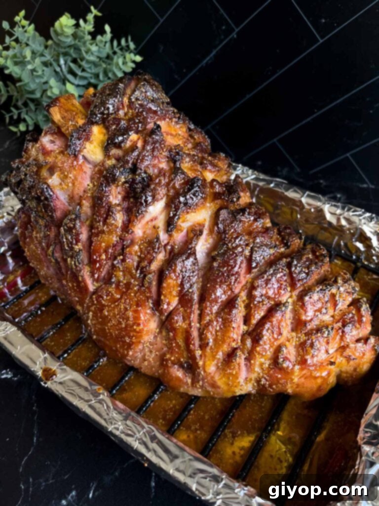 Brown sugar glaze baked on the ham sitting in the roasting pan.