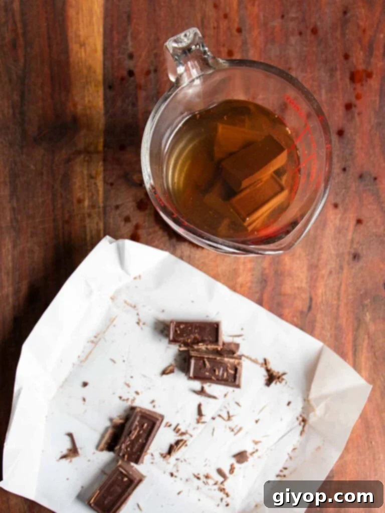 Chocolate squares in a glass measuring cup with boiling water.