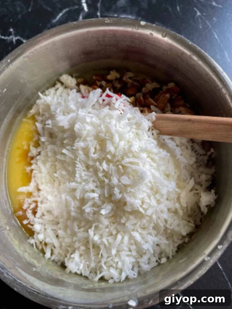 Coconut pecan frosting in a metal mixing bowl.