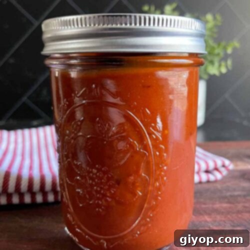 Homemade bourbon chipotle barbeque sauce in a mason jar.
