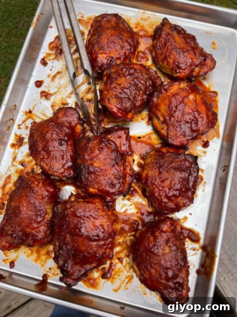barbecued chicken recently pulled from the smoker on a baking sheet.