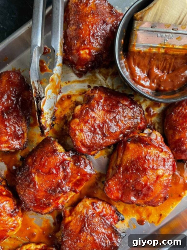 bbq chicken thighs on a baking sheet.