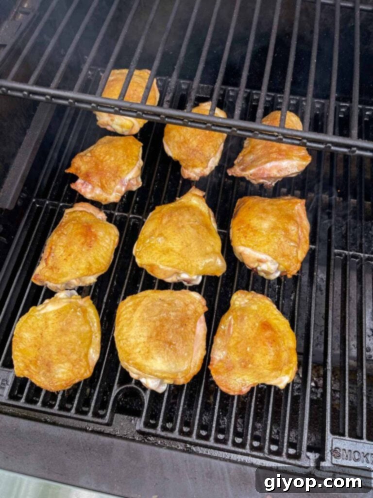 Chicken thighs with crispy skin on the smoker.