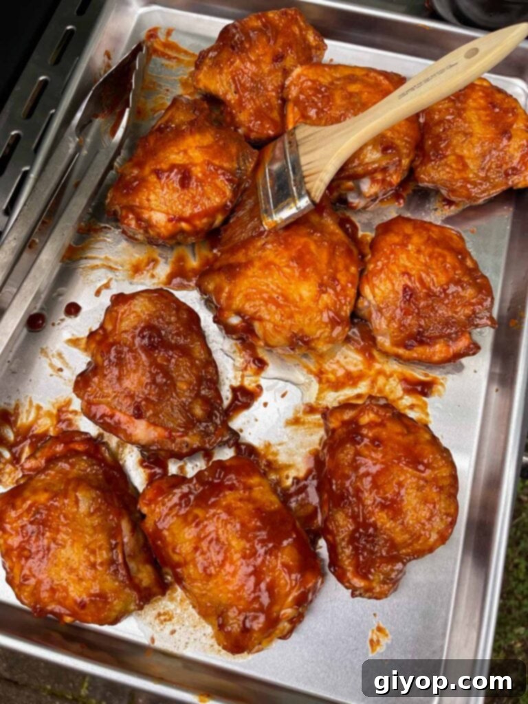 Chicken thighs with a layer of bbq sauce applied.