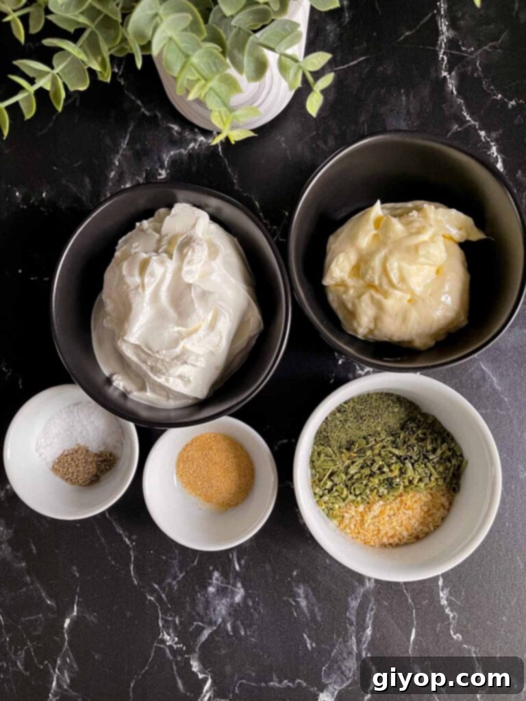 The Ultimate Chip Dip 3 A selection of dried herbs and spices in small ramekins including dried minced onion, chives, dill, and parsley, alongside salt and pepper