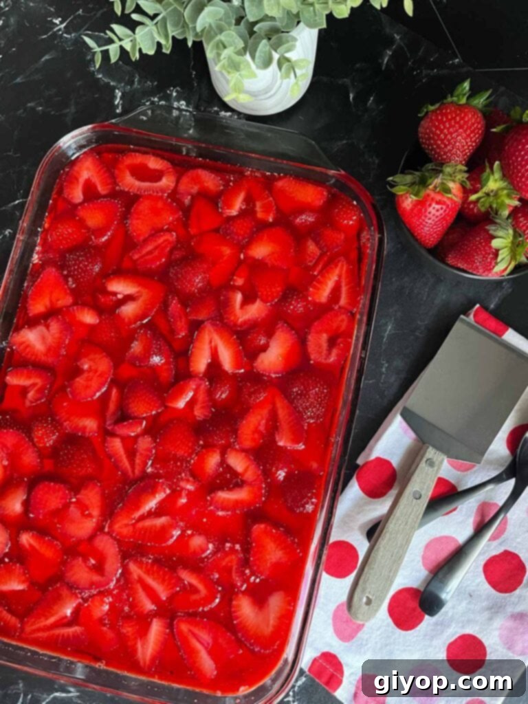 A full dish of homemade Strawberry Pretzel Salad, showcasing its beautiful layers.