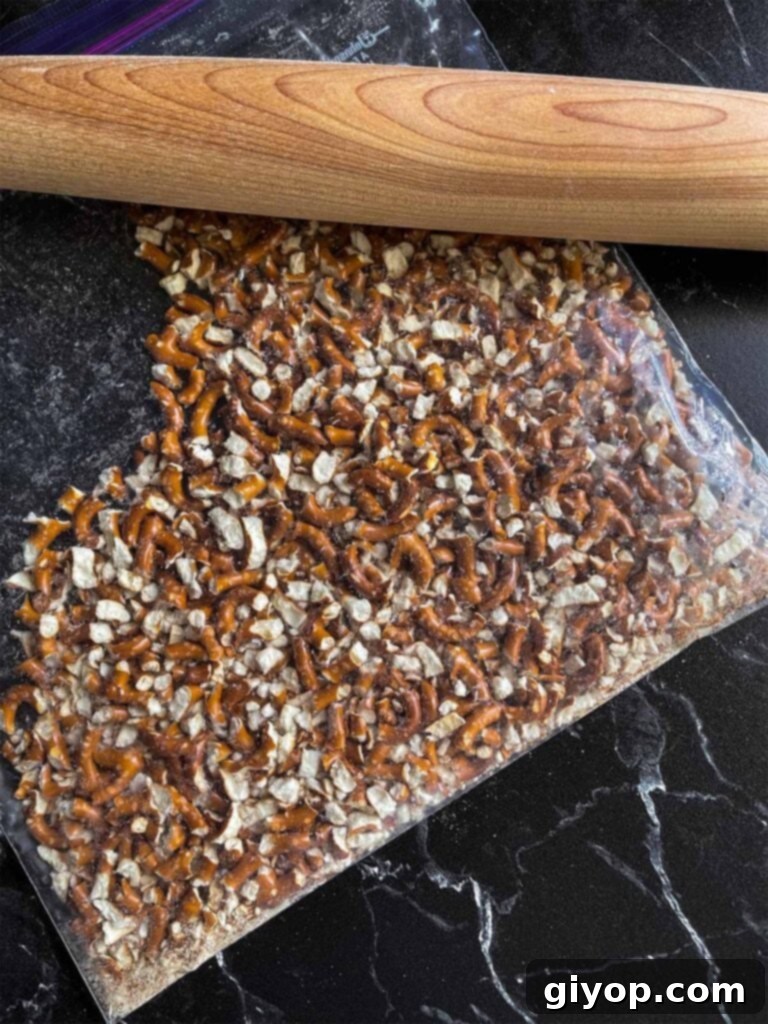 Crushed pretzels in a resealable plastic bag, ready for mixing.