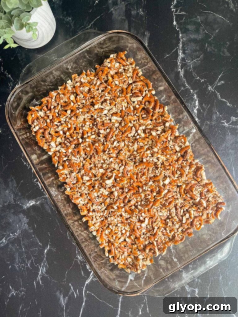 The pretzel crust mixture pressed firmly into a glass 9x13 inch baking dish.