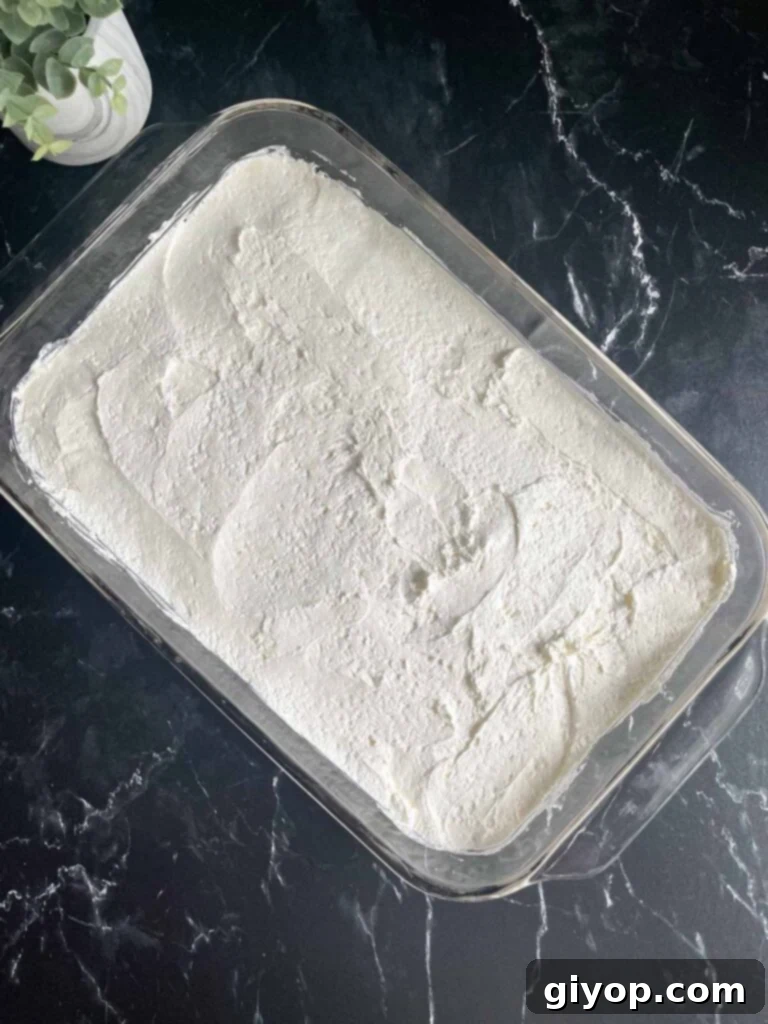 The smooth whipped cream cheese topping spread evenly over the pretzel crust.