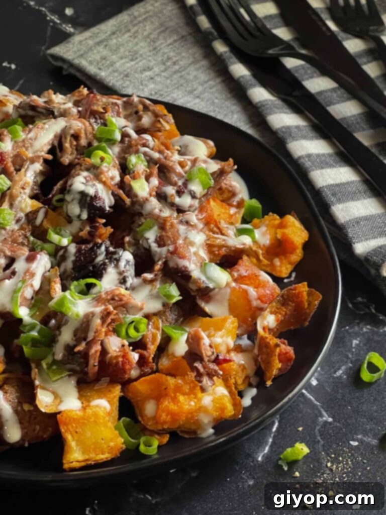 Another enticing angle of loaded potato bites on a black serving plate, ready to be enjoyed.