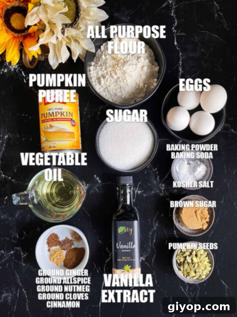 Ingredients for pumpkin bread on a dark surface.
