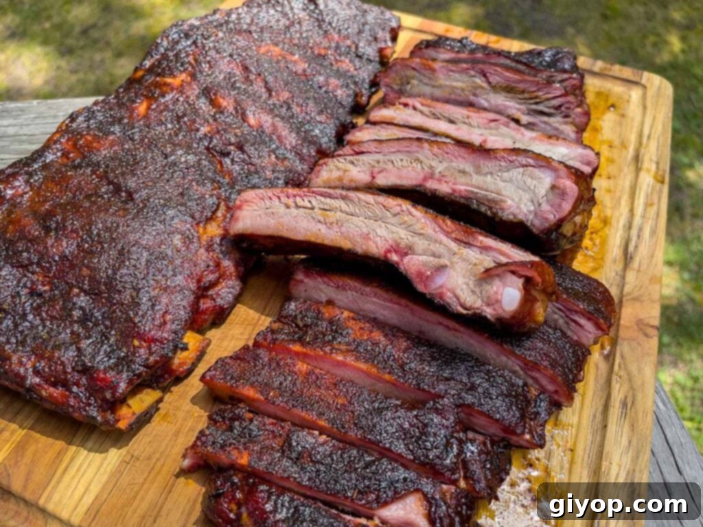 Two racks of St. Louis style ribs on a cutting board, ready to be served.