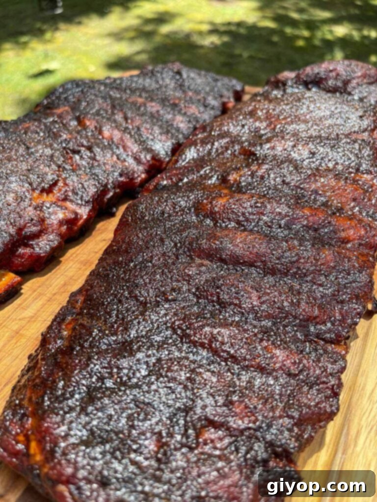 A pristine rack of smoked ribs, fresh off the smoker and ready to rest.