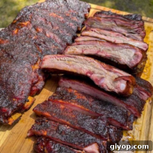 Two racks of St. Louis style ribs on a cutting board, the star of this recipe.