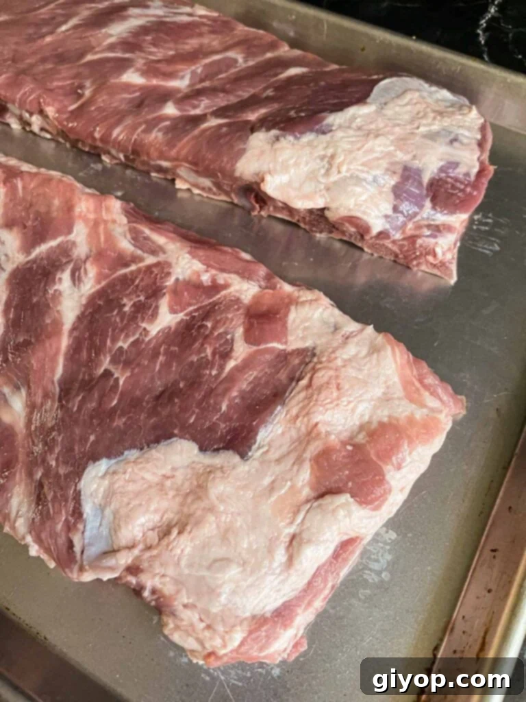 Ribs with visible areas of excess fat that need to be trimmed.