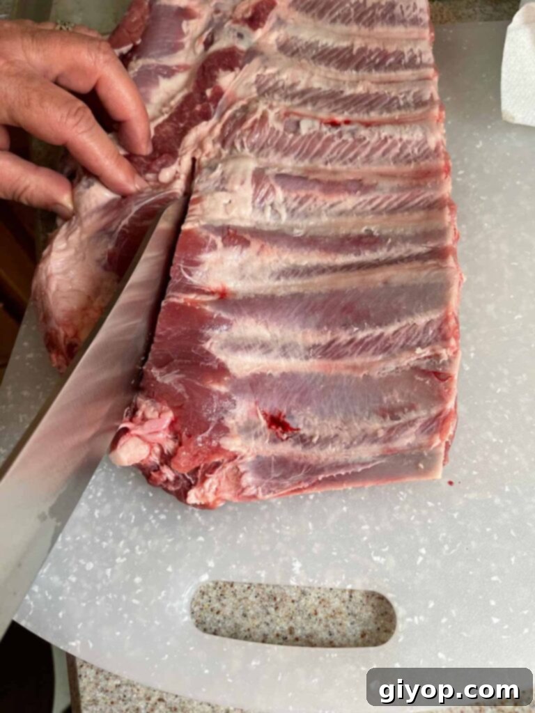 The process of removing the brisket bone and rib tips from spare ribs.