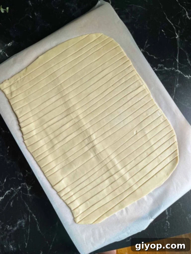 Blueberry Harvest Delight 7 Delicate strips of pie dough, uniformly cut and arranged on a lightly floured surface, prepared for weaving into a decorative lattice crust.