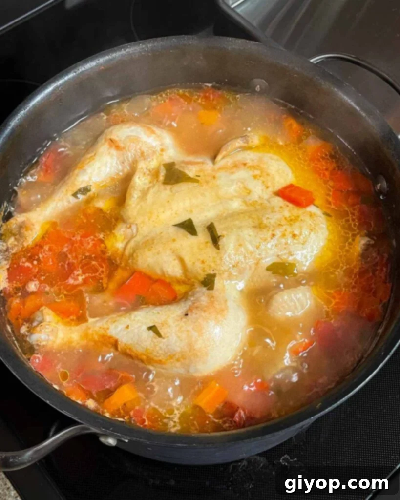 Simmering Sicilian chicken soup in a large stock pot.