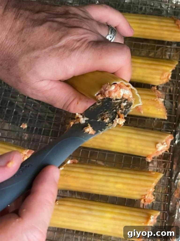 Pitmaster's Smoked Shotgun Shells 5 Stuffing the manicotti shells with the sausage mixture for smoked shotgun shells.