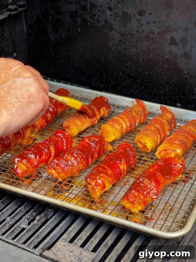 Pitmaster's Smoked Shotgun Shells 8 Applying barbecue sauce to the smoked shotgun shells.