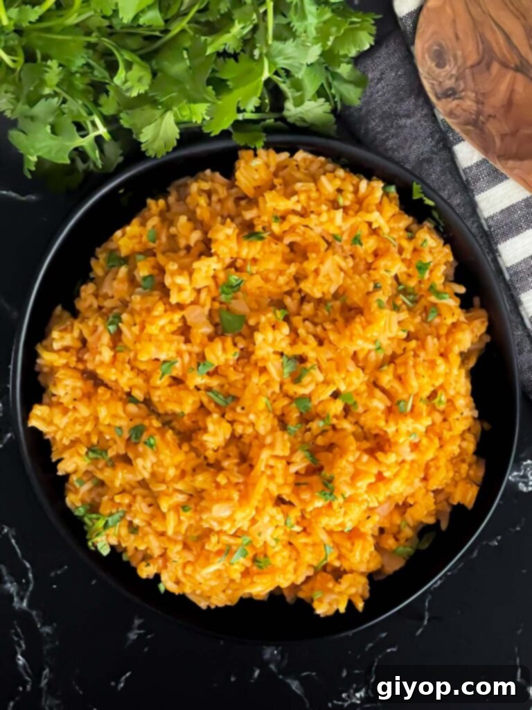 Hearty Mexican red rice served in a dark, rustic bowl, ready for a delicious meal.