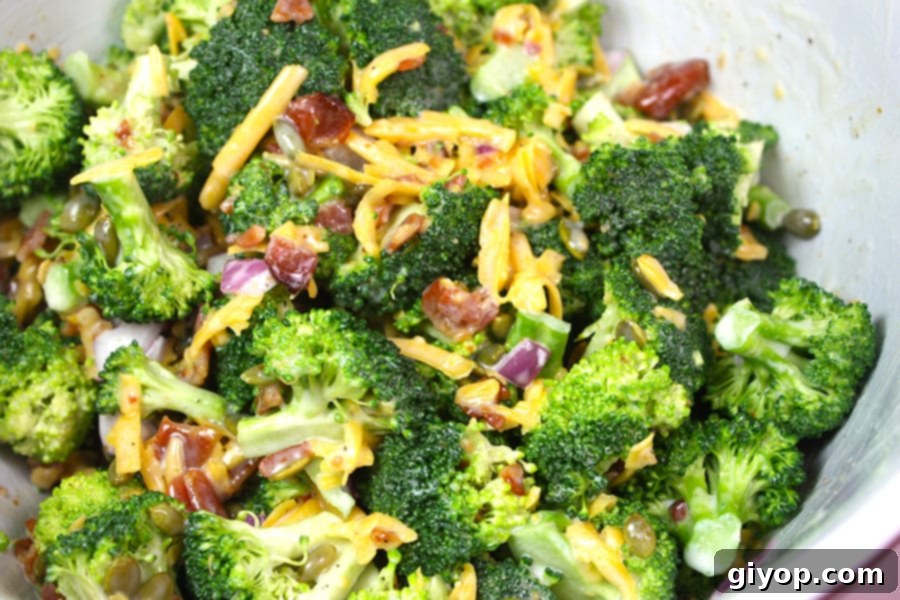 Broccoli salad in a white bowl, ready to be served.