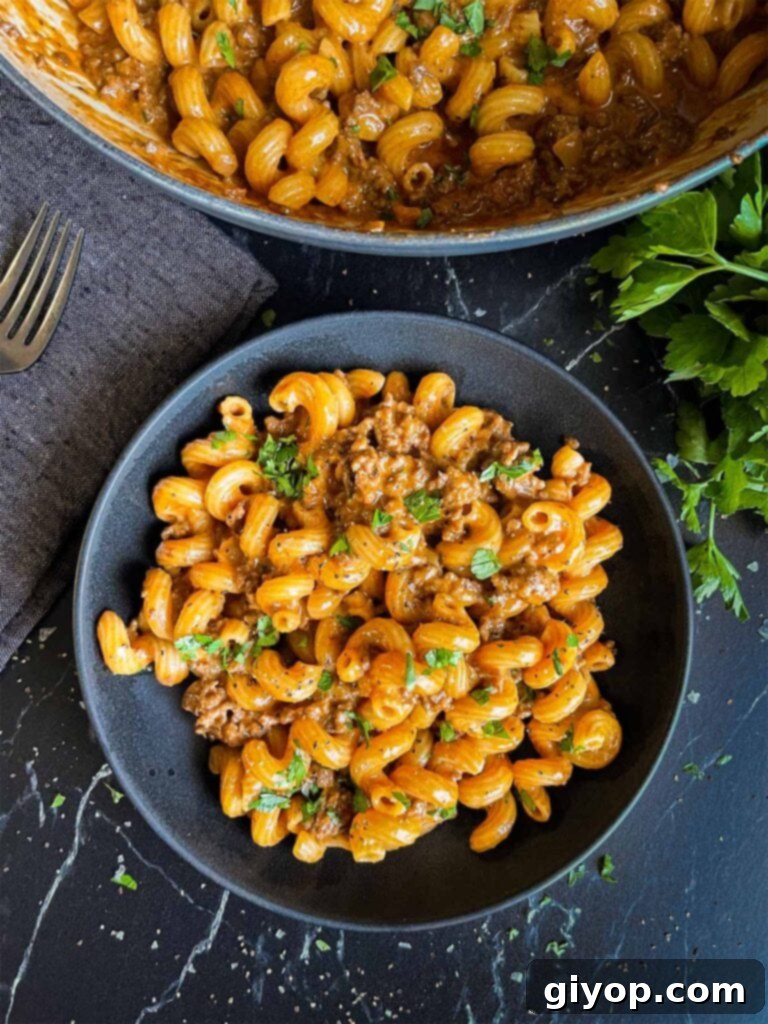 Homemade one pot hamburger helper in a dark bowl.