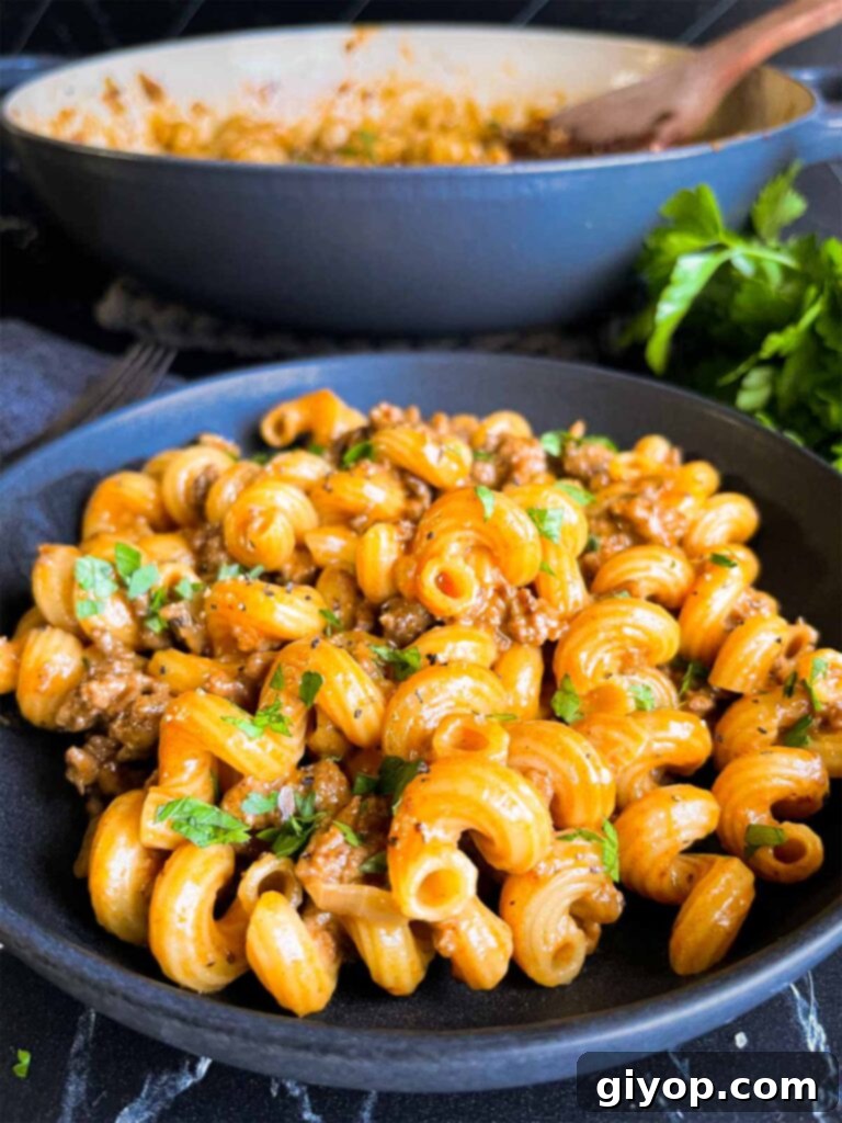 Homemade one pot hamburger helper in a dark bowl.