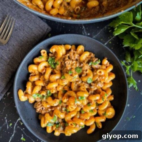 Homemade one pot hamburger helper in a dark bowl.