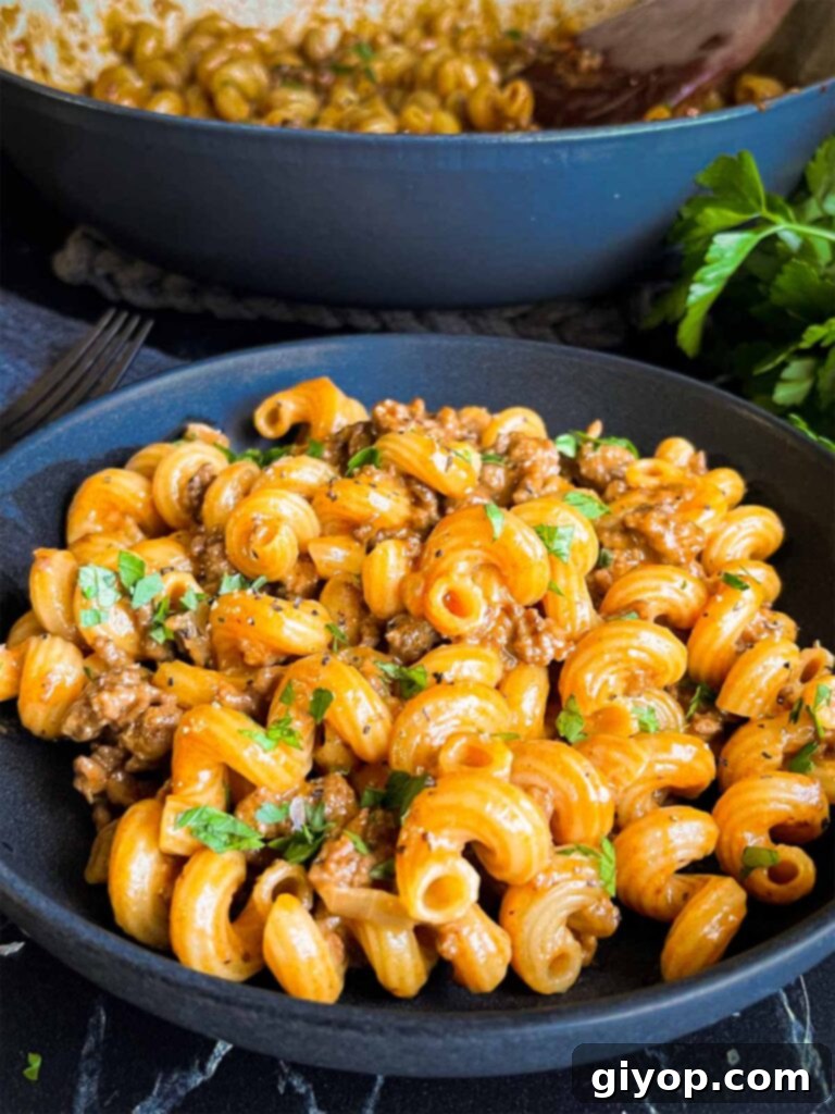 Homemade one pot hamburger helper in a dark bowl.