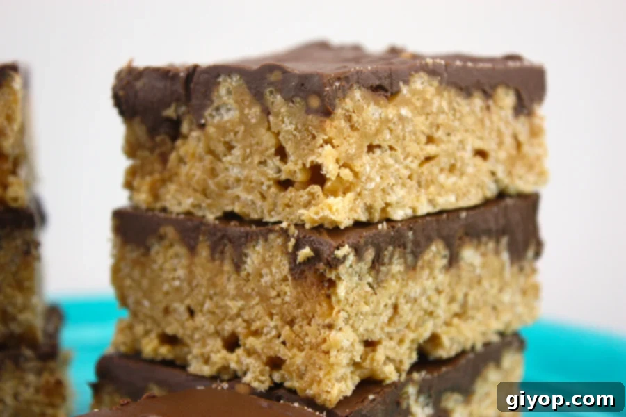 Scotcharoos stacked on a blue plate.