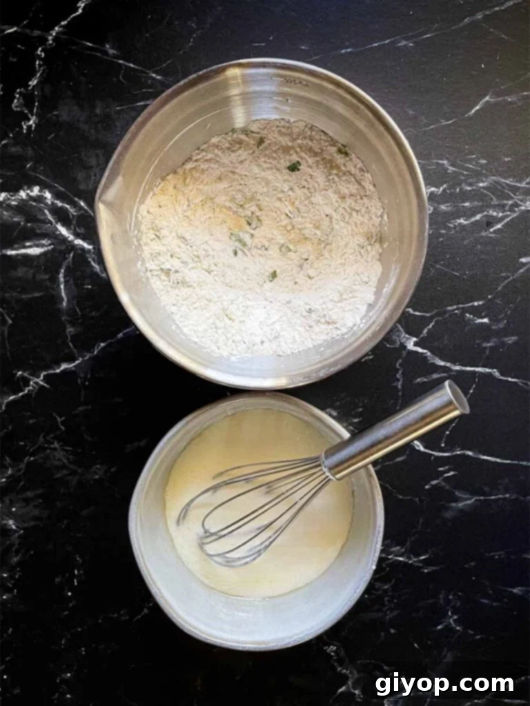 Separate stainless steel bowls containing dry and wet ingredients for the dumpling dough, ready to be combined.