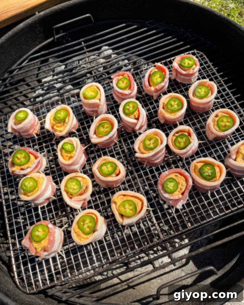 Pitmaster's Piggy Poppers 12 Pig shots smoking in a Weber grill.