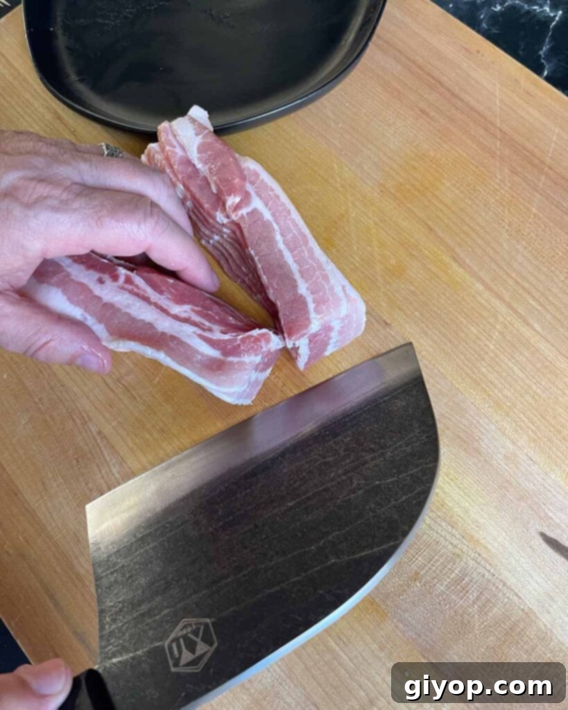 Pitmaster's Piggy Poppers 6 Cutting bacon in half on a cutting board.