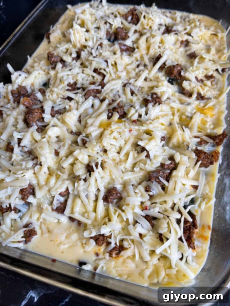 Cheesy Chile Relleno Bake 12 Chile relleno casserole in glass baking dish ready to be baked.