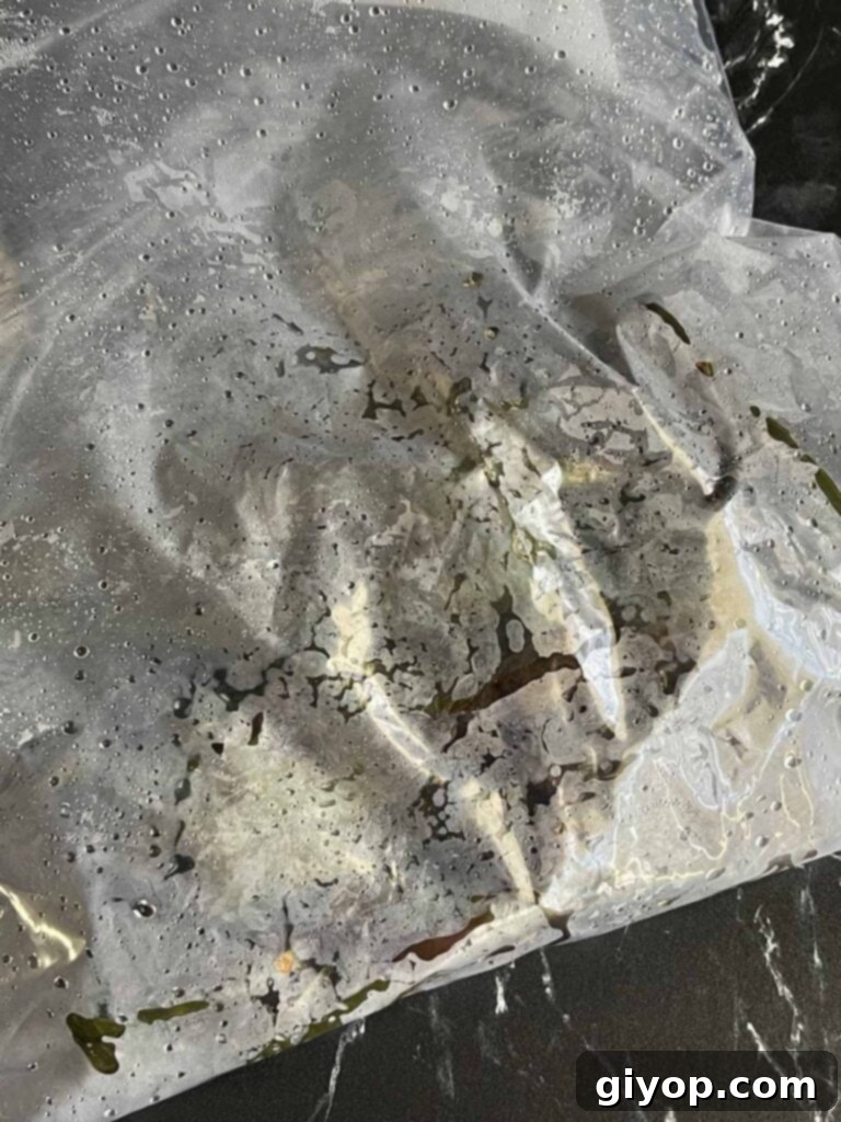 Cheesy Chile Relleno Bake 8 Roasted poblanos sweating in a plastic bag.