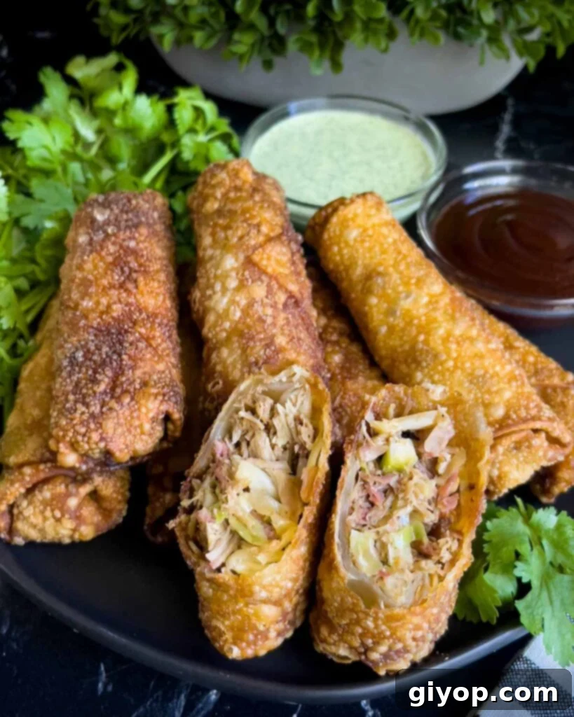 Redneck egg rolls on a dark plate. One is cut in half and standing up.