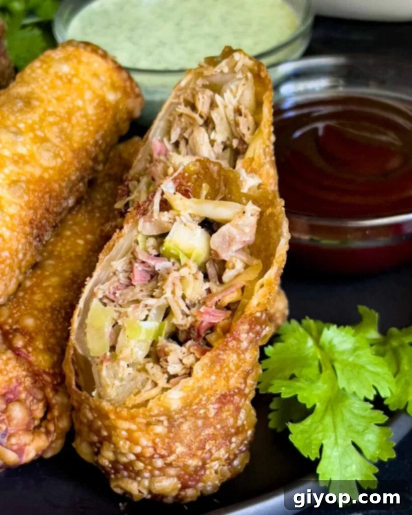 Redneck egg rolls on a dark plate with dipping sauces.